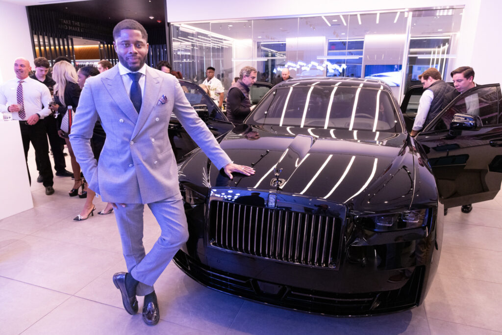 Event photography image of a man standing next to a rolls royce.