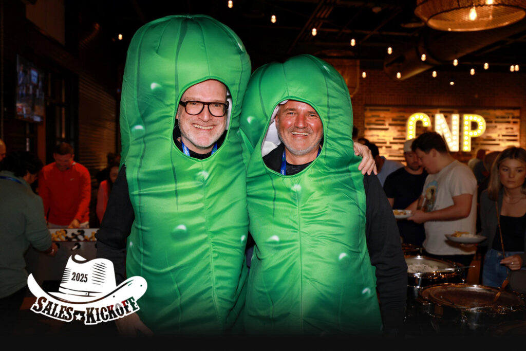 two men wearing pickle costumes.