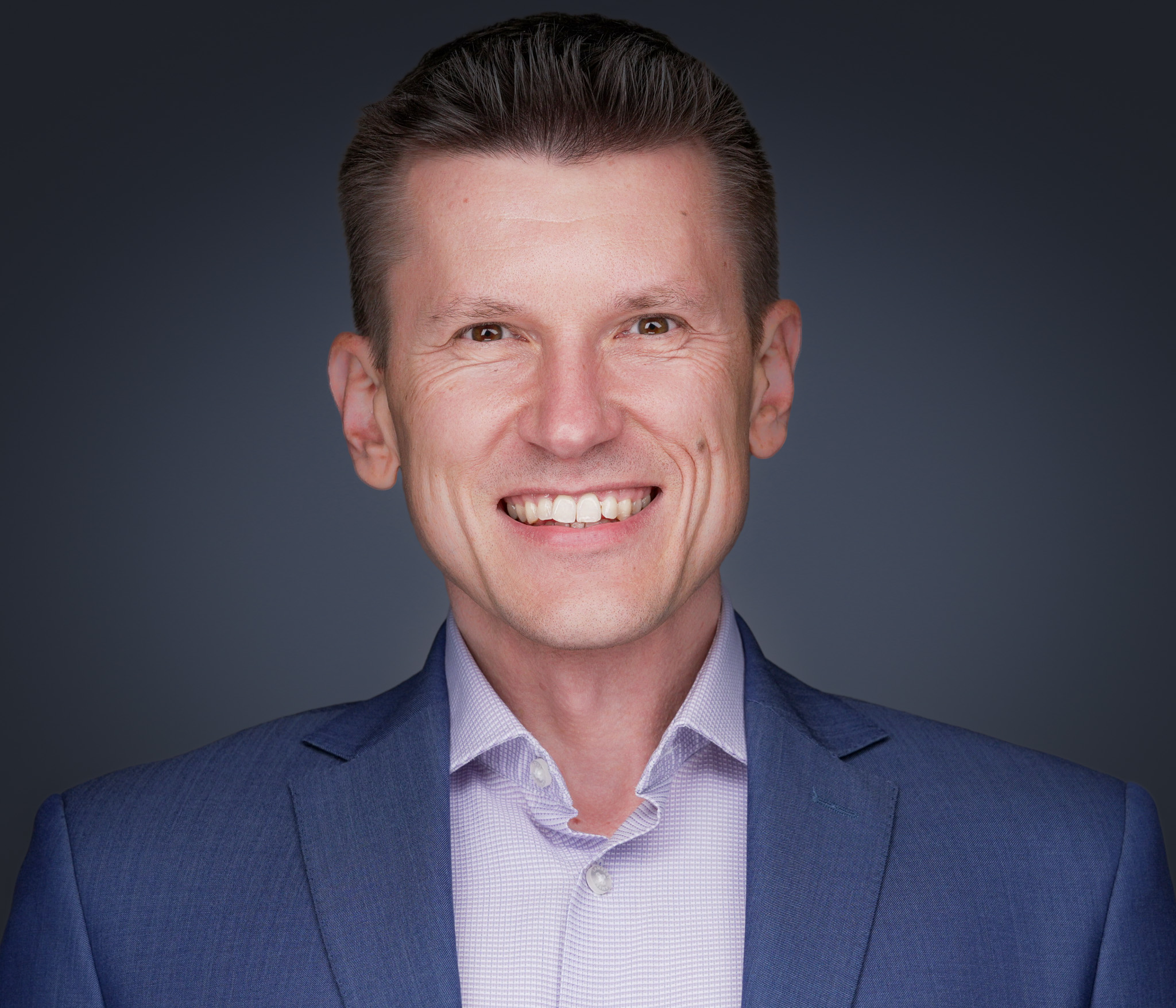 Small business owner alongside 2-3 key staff members, all photographed with matched lighting and consistent crop by 2mm Headshots — demonstrating the SMB small-team package value