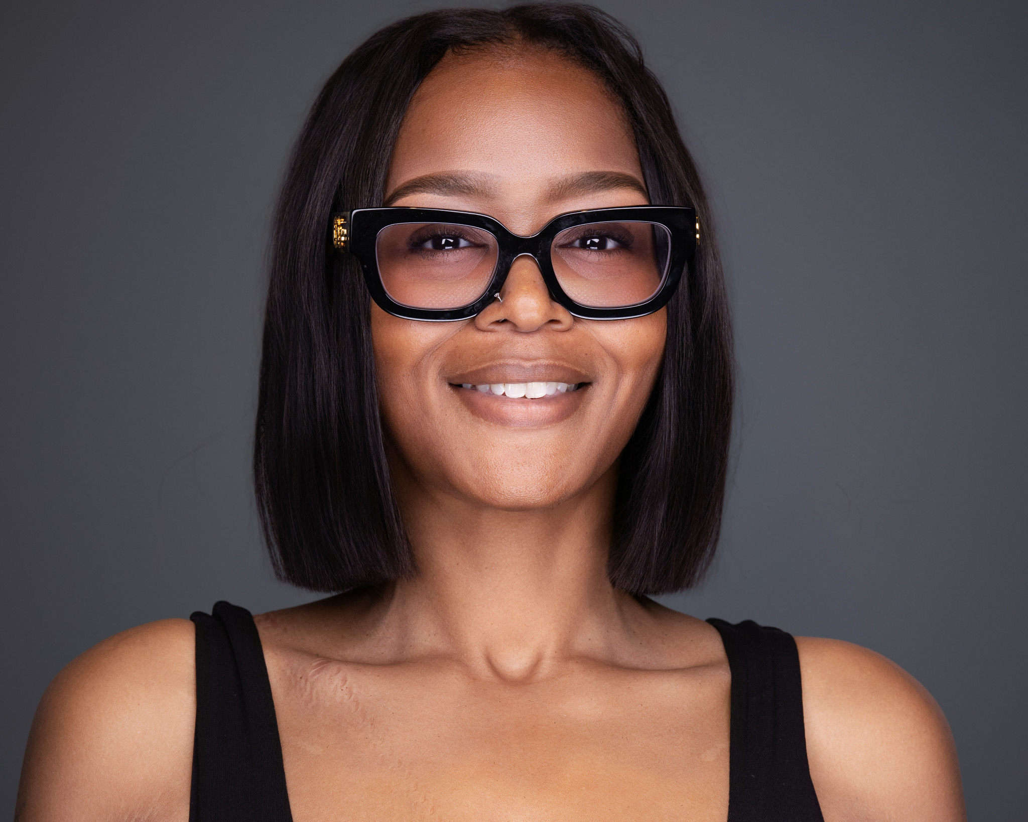 Individual Professional Headshot on Charcoal Background — Warm, Approachable, 2mm DFW - 2MM Headshots and Event Photography Warm, approachable individual professional headshot on a clean charcoal background, photographed by 2mm Headshots in North Richland Hills, Texas