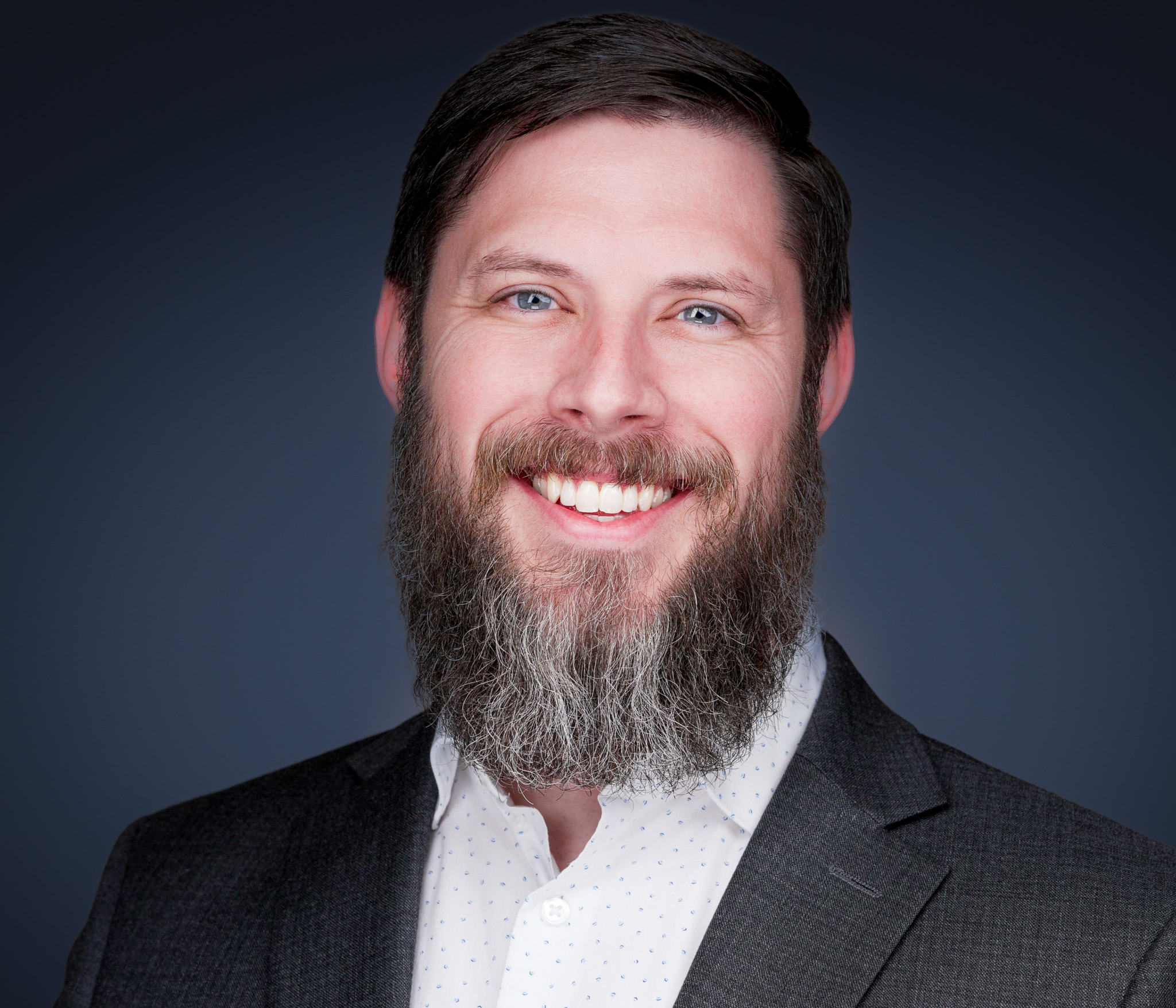 Professional employee headshot with matched lighting and background