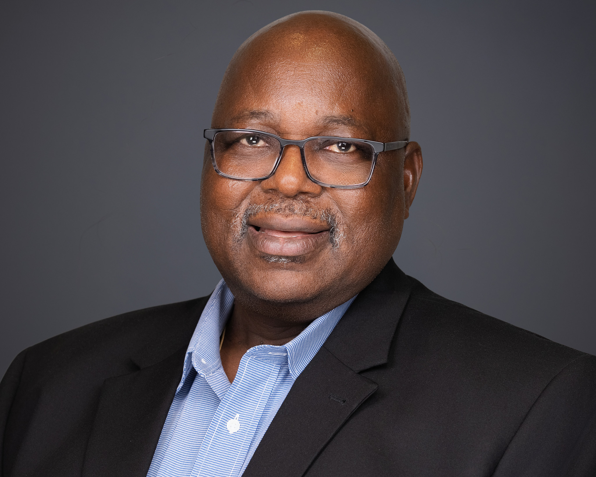 Executive headshot of a corporate leader with professional lighting