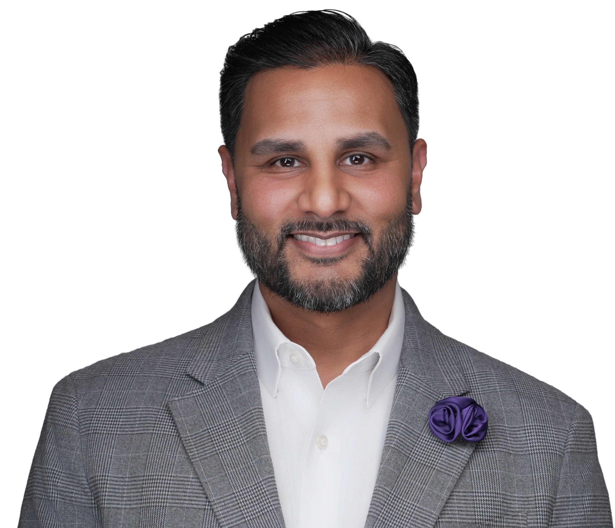 Smiling man in a gray blazer and white shirt, studio headshot against a white backdrop