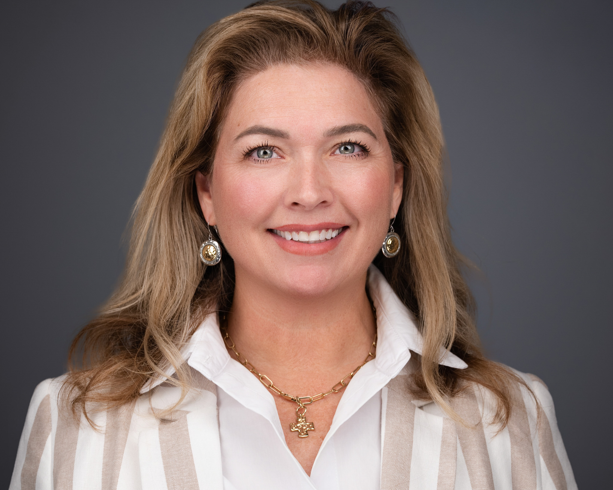 Corporate executive headshot with a confident expression and clean studio lighting