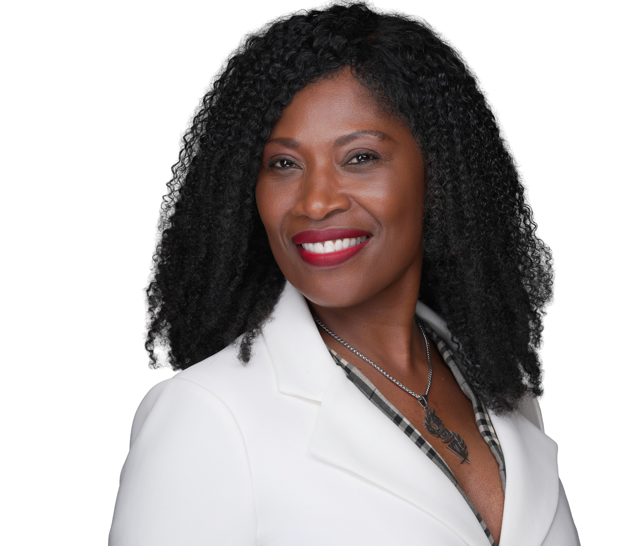 Smiling woman with dark curly hair in a white blazer, studio headshot against a white backdrop
